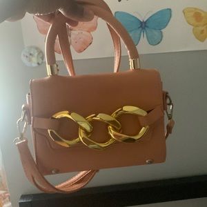 I’m selling a pink purse with gold on it